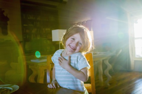 Sunshine on Caucasian boy sitting at table