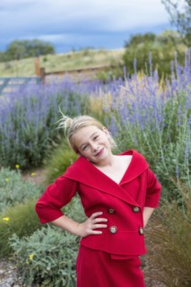 Caucasian girl wearing red dress in field