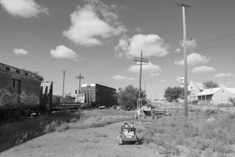 Caucasian boy driving toy car near train