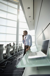Businessman talking on cell phone in conference room