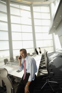 Businessman talking on cell phone in conference room