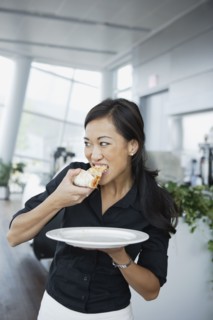 Asian woman eating pizza