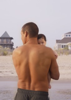 Mixed Race father holding baby