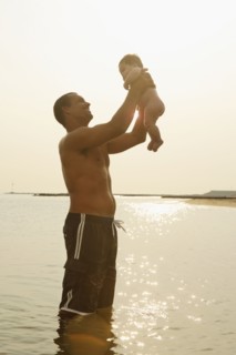 Mixed Race father holding baby