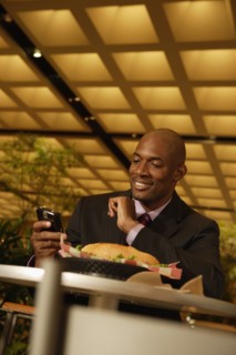 African businessman looking at cell phone