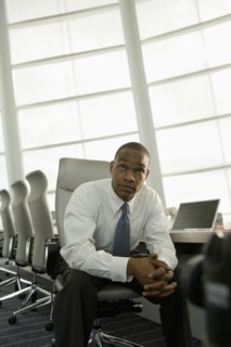 African businessman in conference room looking impatient