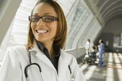 African doctor smiling in corridor