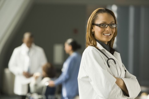 African doctor with arms crossed smiling