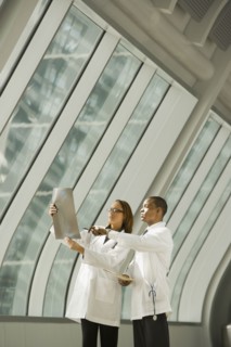 African doctors reviewing x-rays by window