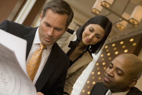 Multi-ethnic business people reviewing paperwork