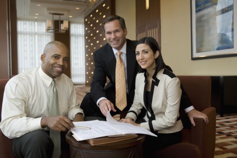 Multi-ethnic business people posing in lobby