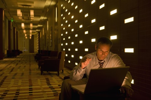 Businessman working on laptop late in lobby