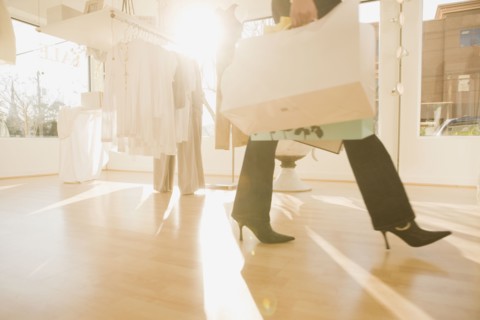 Multi-ethnic women holding shopping bags in shop