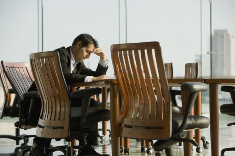 Worried businessman waiting in conference room for meeting