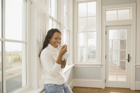 African woman eating in empty room