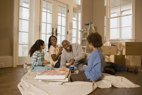 Family eating on floor in new home
