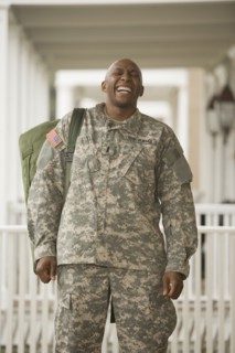 African man in military uniform laughing