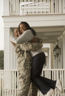 African soldier hugging girlfriend