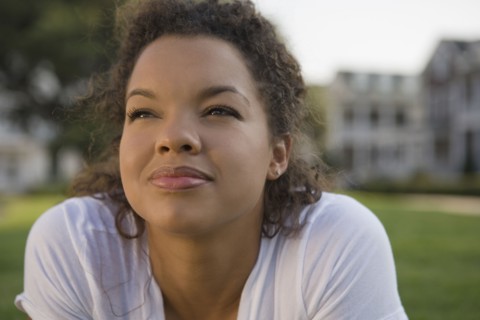 Mixed race woman looking up outdoors
