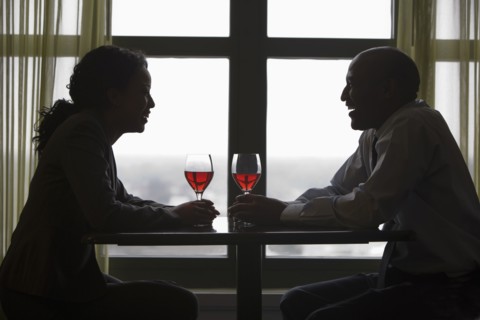 African couple drinking red wine