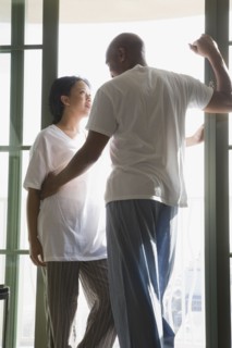 African couple in pajamas hugging