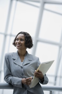 African businesswoman holding paperwork