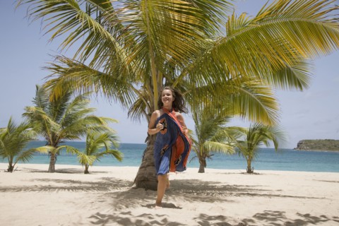 Girl in sarong running on beach