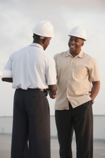 African businessmen in hard-hats shaking hands