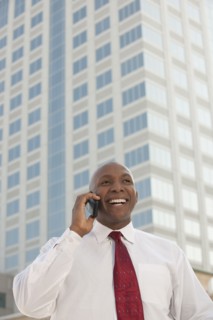Black businessman talking on cell phone outdoors
