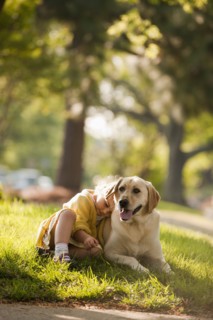 Caucasian girl playing with dog in yard