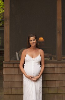 Pregnant Caucasian woman smiling outdoors