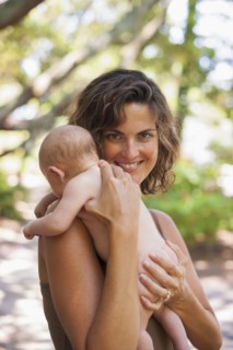 Caucasian mother holding baby outdoors