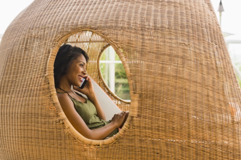 African American woman talking on cell phone in cabana