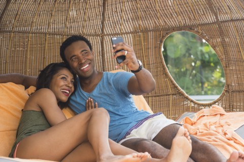 Couple taking selfie in cabana