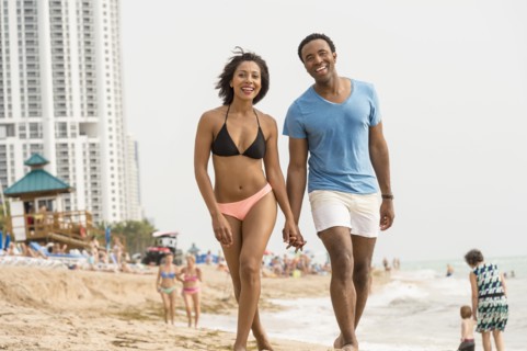 Couple holding hands on beach