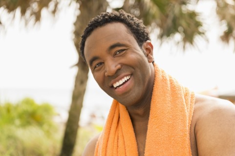 Black man smiling on beach