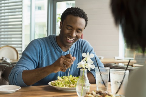Black man eating breakfast in cafe