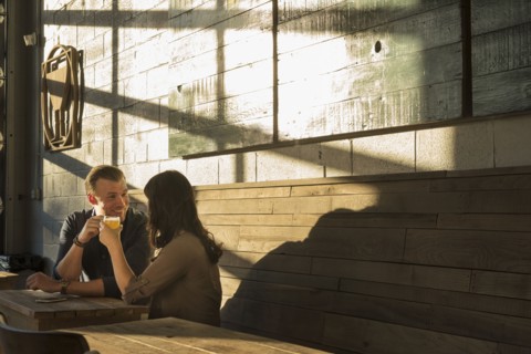 Caucasian couple talking in brew pub