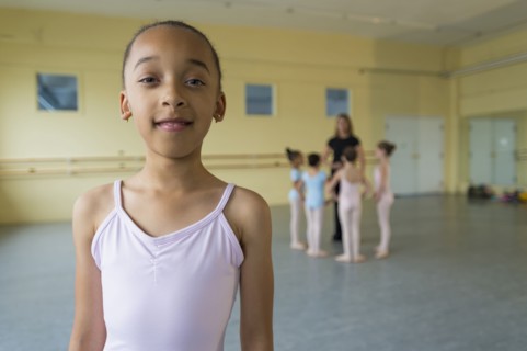 Portrait of smiling girl in ballet studio