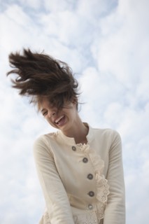 Mixed race girl flipping hair outdoors