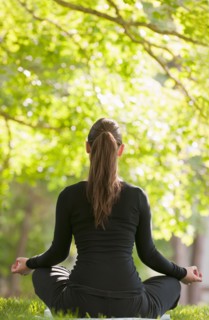 Caucasian woman practicing yoga in park