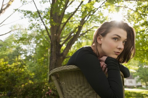Caucasian woman sitting in chair outdoors