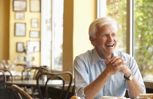 Smiling Caucasian man having lunch in restaurant