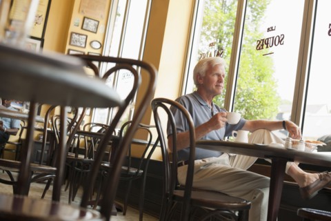 Caucasian man drinking coffee in restaurant