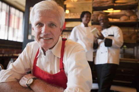 Caucasian waiter sitting in restaurant