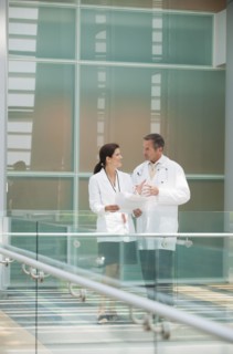 Doctors talking together near hospital railing