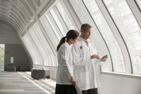 Doctors talking together in hospital corridor