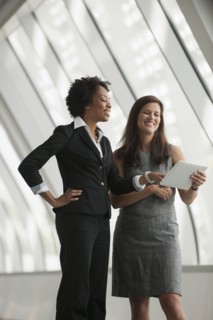 Businesswomen using digital tablet together