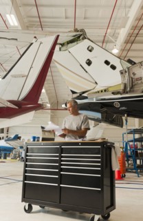 Caucasian man working in airplane hangar
