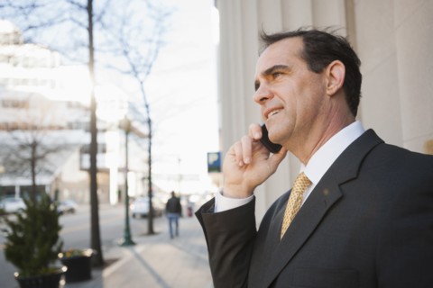 Caucasian man talking on cell phone outdoors